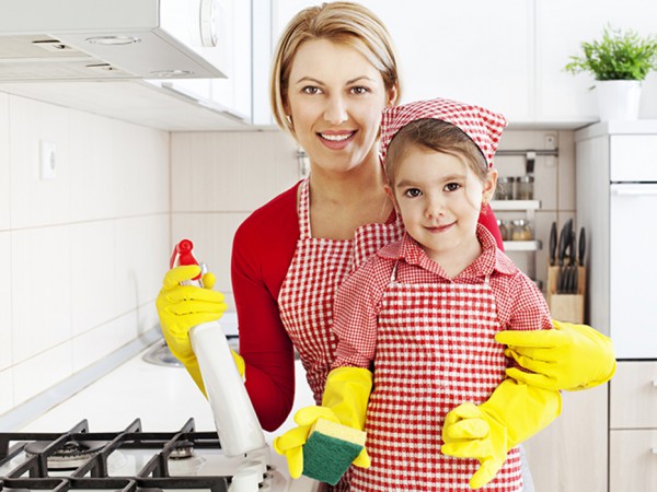 Mother and daughter cleaning the kitchen together