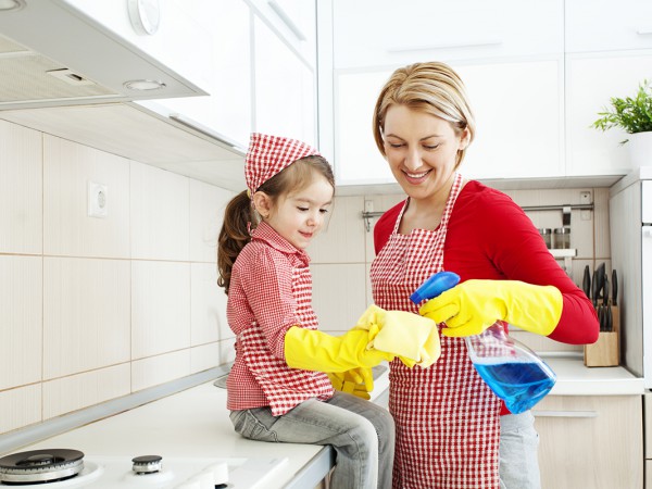 Mother and daughter cleaning in the kitchen